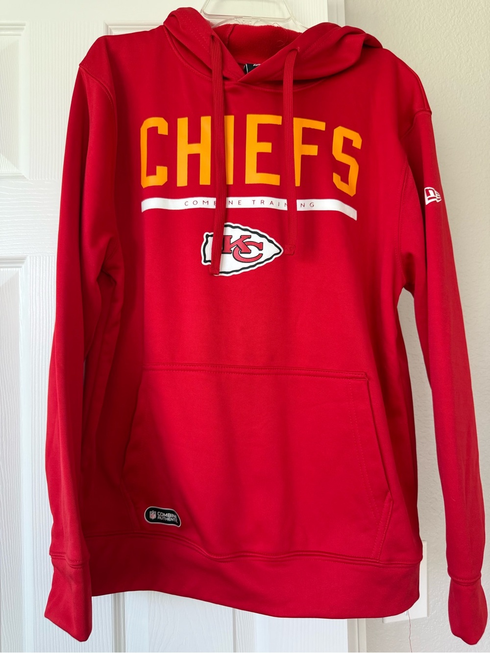 Like new, New Era Red NFL Team Hoodie with Yellow Accent